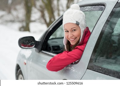 Woman Driving In Winter On Snow Covered Slippery Road In Forest