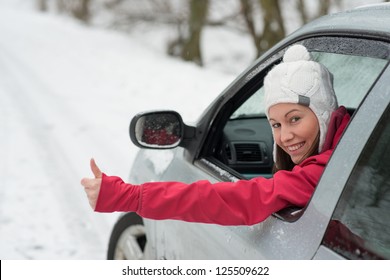 Woman Driving In Winter On Snow Covered Slippery Road In Forest