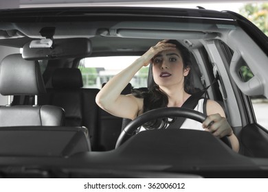 Woman Driving Worried With Hand On Forehead