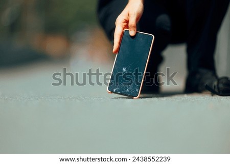 

Woman Dropping her Smartphone on the Pavement Breaking it. Unlucky girl smashing her mobile screen on the concrete floor
