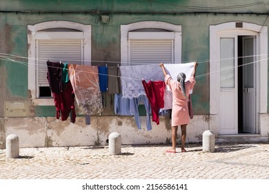 woman drying clothes on the street