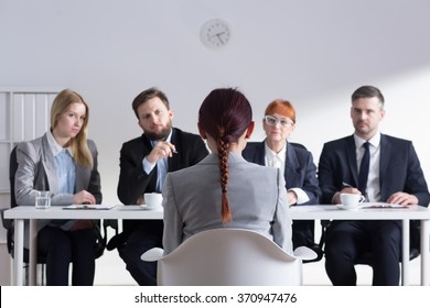 Woman during job interview and four elegant members of management - Shutterstock ID 370947476