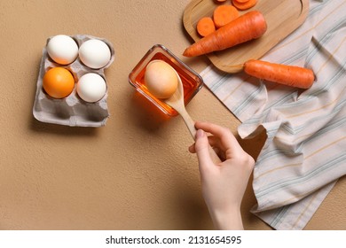 Woman Dying Easter Eggs On Color Background