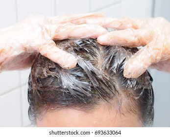 Woman Dying Her Hair With Hair Dye Shampoo.