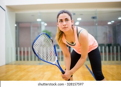 Woman eager to play squash in the squash court