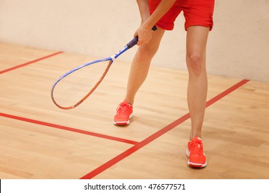 Woman eager to play squash in the squash court