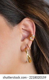 Woman ear with mulriple piercings wearing beautiful earrings with zirconia- details capture.  Beautiful valentine's gift. - Shutterstock ID 2218020159