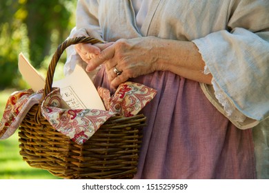 Woman In Early American Costume Holding Basket