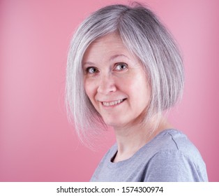 Woman In The Early Fifties With Gray Hair, Pink Background