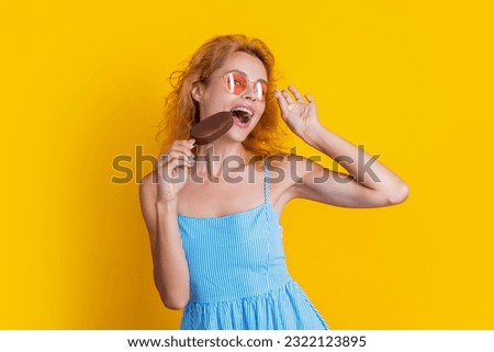 woman eat icecream in studio. woman with icecream on background. woman with icecream at summer. woman with icecream isolated on yellow.