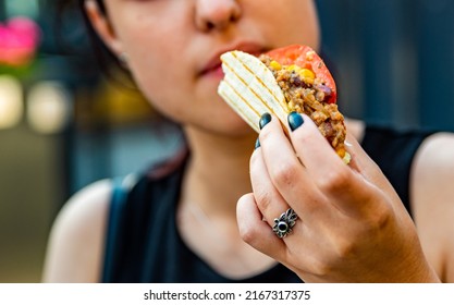 woman eat taco outdoor traditional in mexican food. street food