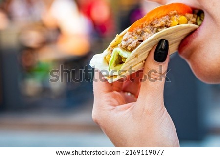 woman eat taco outdoor traditional in mexican food. street food