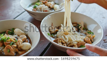 Woman eat thiland boat noodles