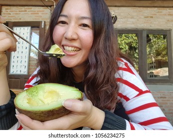 Woman Eating Avocado