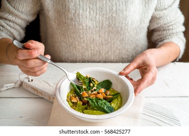 Woman Eating Avocado Cream With Almond And Spinach  Horizontal