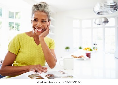 Woman Eating Breakfast And Reading Magazine - Powered by Shutterstock