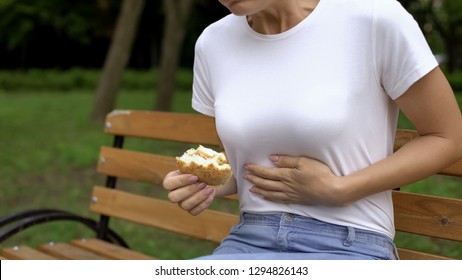 Woman Eating Burger In Park, Feeling Nausea, Food Poisoning Symptom, Gastritis