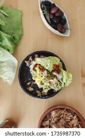Woman Eating A Chicken Wrap Holding It With Both Hands At Home. Fresh Lettuce Wraps Delicious Option For Lunch Or Dinner. Healthy Lettuce