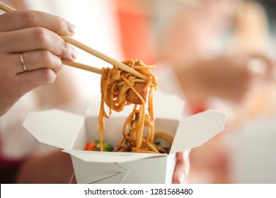 Woman Eating Chinese Noodles From Takeaway Box, Closeup