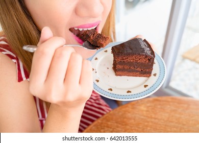 Woman Eating Chocolate Cake