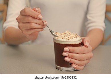 Woman Eating Chocolate Mousse With Spoon  On Table