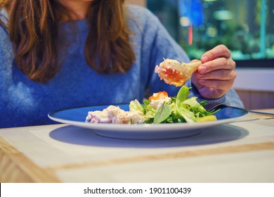 Woman Eating Crab Claw In The Seafood Restaurant. Dinner At The Fish Cafe