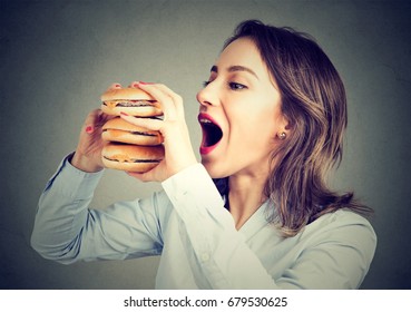Woman eating craving a tasty double burger 