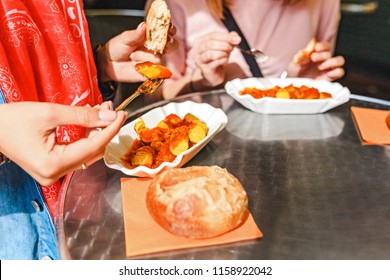 Woman Eating Currywurst With Bread In Berlin Street Food Cafe. Local German Cuisine Concept