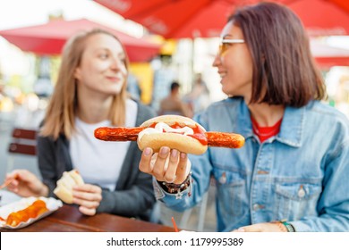 Woman Eating Currywurst Fast Food German Sausage In Outdoor Street Food Cafe