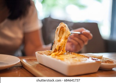 Woman Eating A Delicious Lasagna