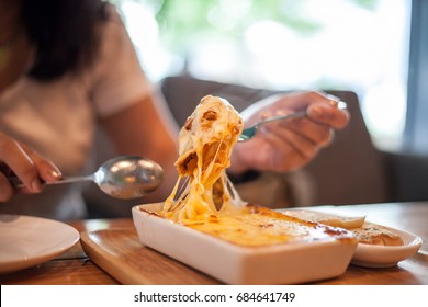 Woman Eating A Delicious Lasagna