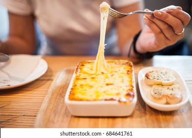 Woman Eating A Delicious Lasagna