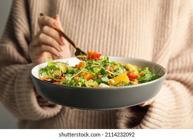 Woman Eating Delicious Salad With Lentils And Vegetables, Closeup