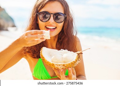 Woman Eating Durian On A Beach 