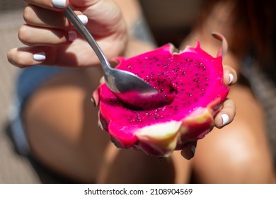 Woman Eating An Exotic Fruit. Ripe Dragon Fruit, Pitaya Or Pitahaya. Close Up Shot.