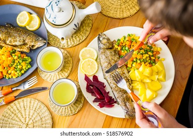 Woman Eating Fish (trout) Dinner