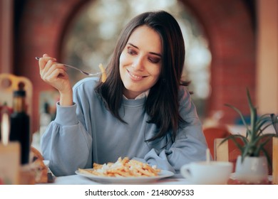 
Woman Eating French Fries With Cheese In A Restaurant. Girl Eating What She Wants In Moderation Following An Intuitive Eating Diet
