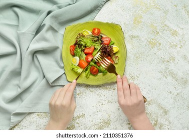 Woman Eating Fresh Salad With Salmon And Vegetables On White Background