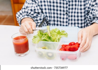 Woman Eating Fruit And Vegetables In The Kitchen.healthy Lifestyle Concept