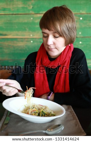 Woman Eating Funchoza Salad in a restaurant
