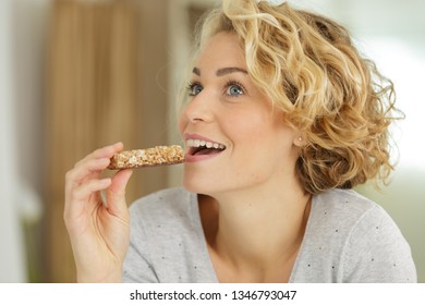 Woman Eating Grain Cereal Bar