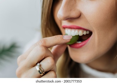 Woman eating a green grape