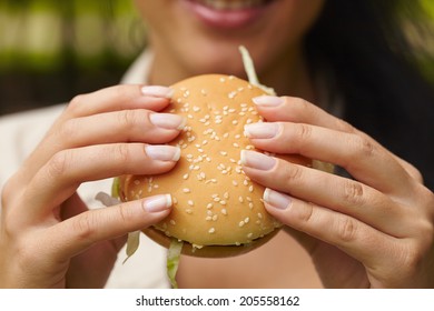 Woman Eating Hamburger