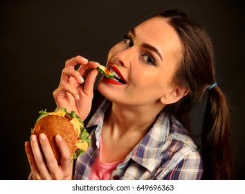 Woman Eating Hamburger. Girl With Flirty Gaze Wants To Eat Burger. Student Consume Fast Food. Person With Good Appetite Is Going To Have Dinner Delicious Sandwich On Black Background.