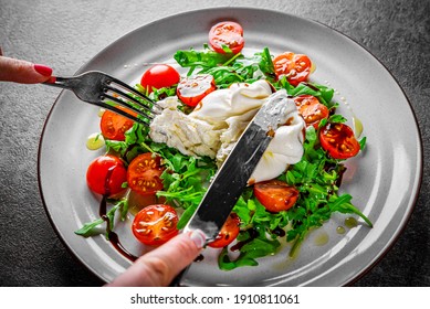 Woman Eating Healthy Salad With Burrata Cheese, Arugula Salad And Tomatoes