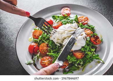 Woman Eating Healthy Salad With Burrata Cheese, Arugula Salad And Tomatoes