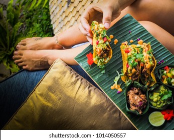 woman eating healthy vegan jackfruit tacos