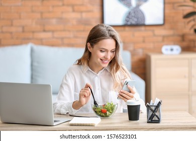 Woman eating healthy vegetable salad in office - Powered by Shutterstock