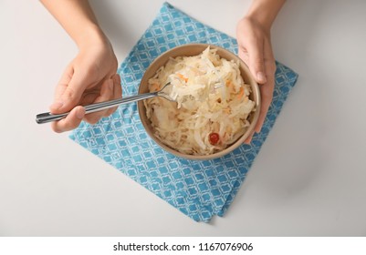 Woman Eating Homemade Sauerkraut At White Table