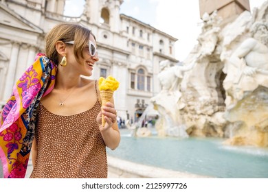 Woman eating ice cream in cone while visiting famous Navona square near fountain in Rome. Concept of happy summer vacations, traveling famous italian landmarks